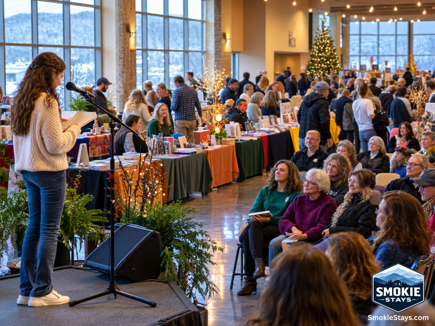 A teenage student performs an original poem at the Appalachian WordFest Poetry Slam in Sevierville, Tennessee, while behind her, visitors browse author tables and book displays filling the Event Center at The Ridge on a winter morning.